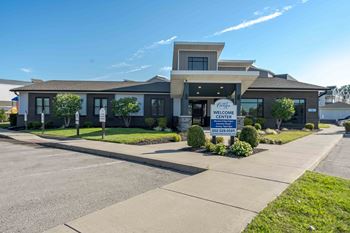 A building with a sign that says "Welcome Center" in front of it.
